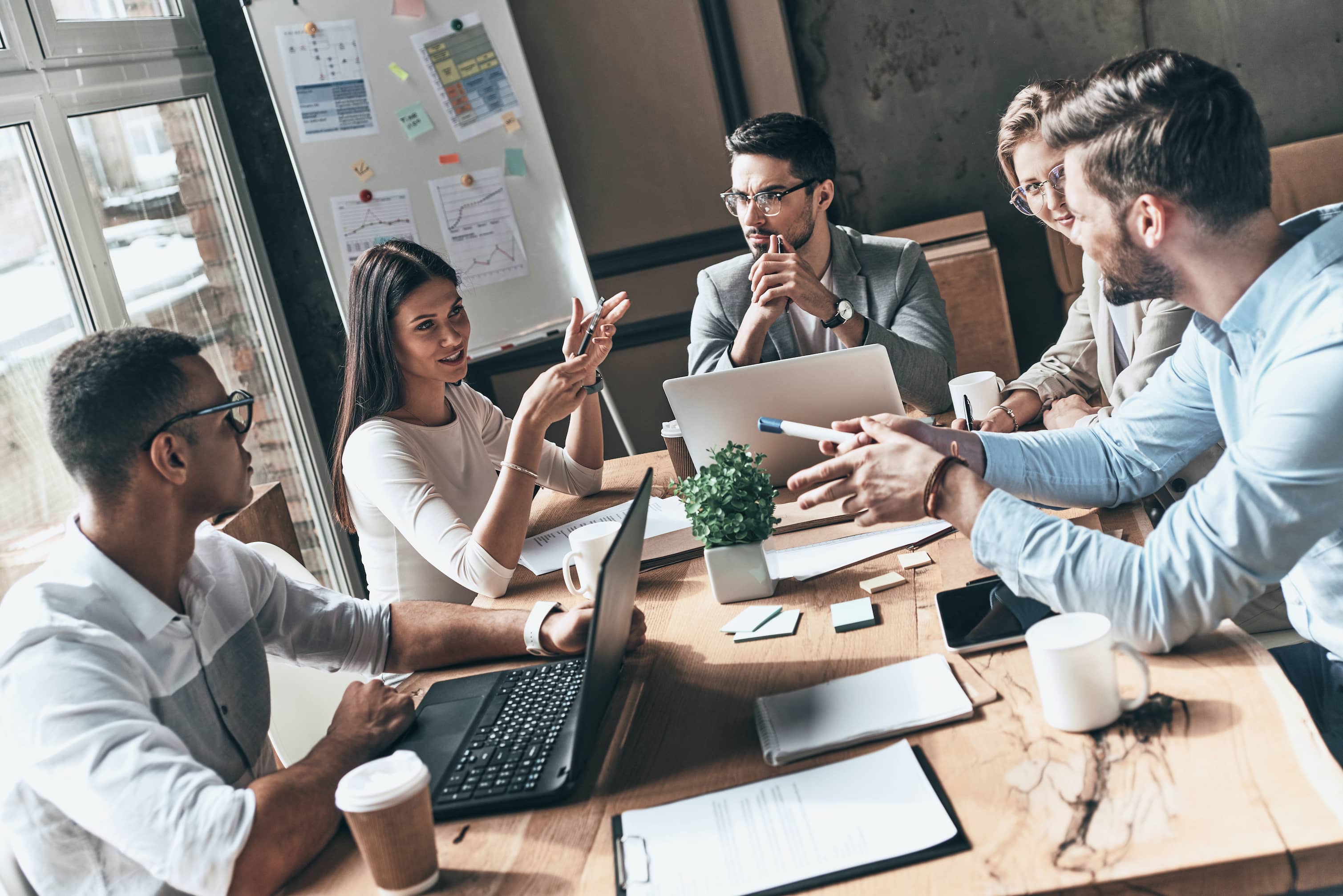 A team at work with computers meeting to discuss a new project