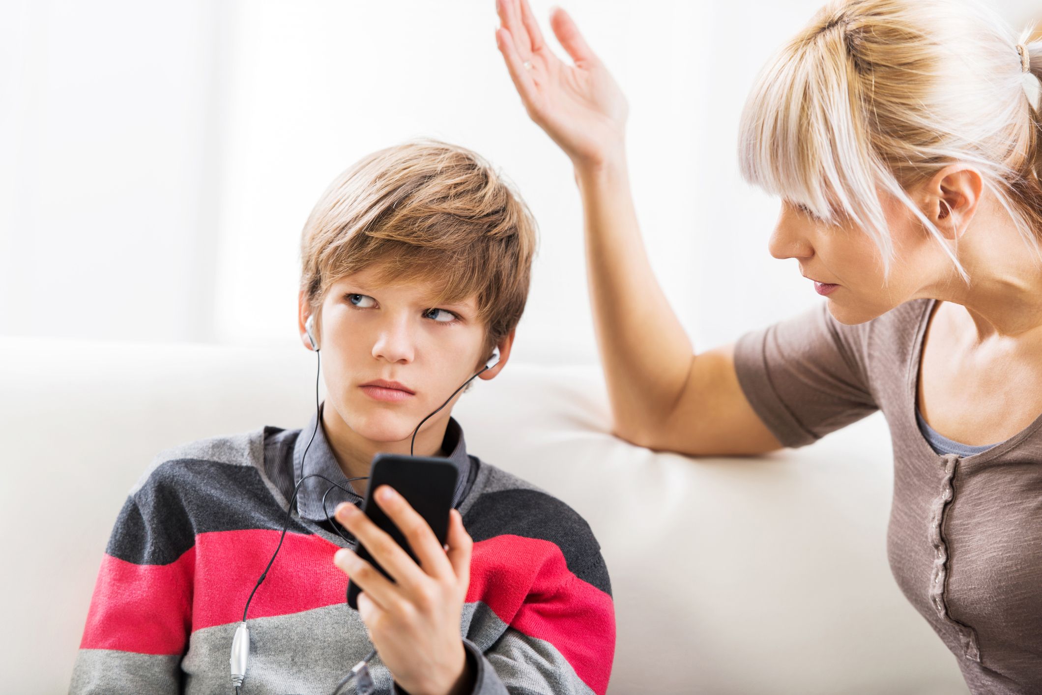 Teen tuning out his upset mom yelling