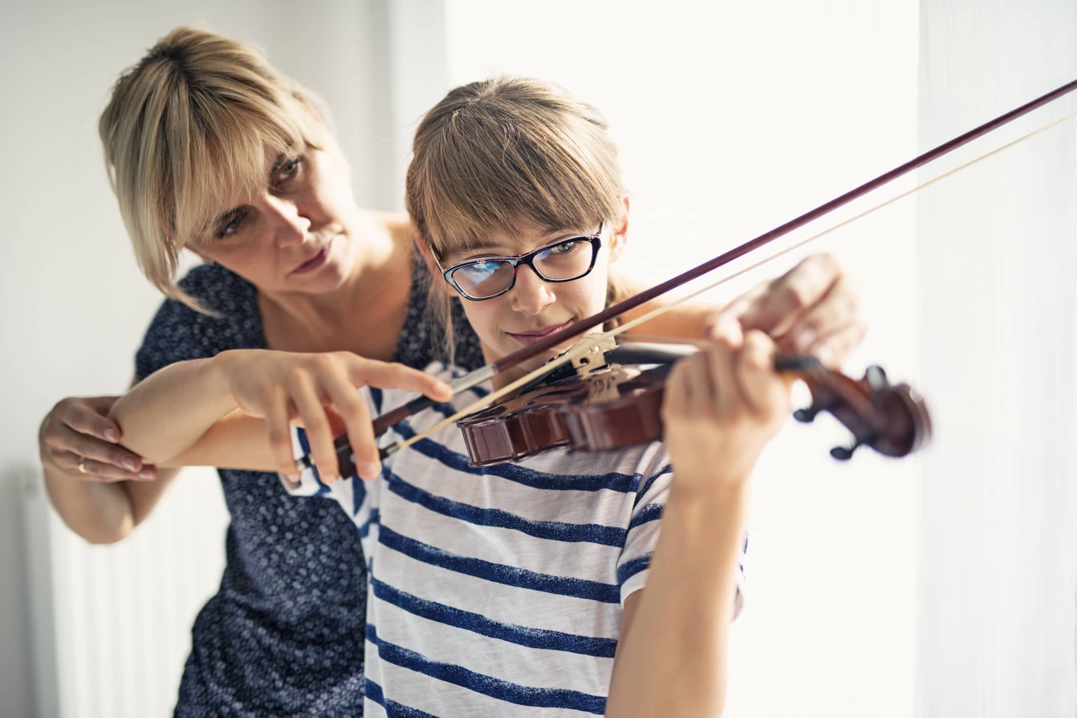 A teenage girl at violin lessons.