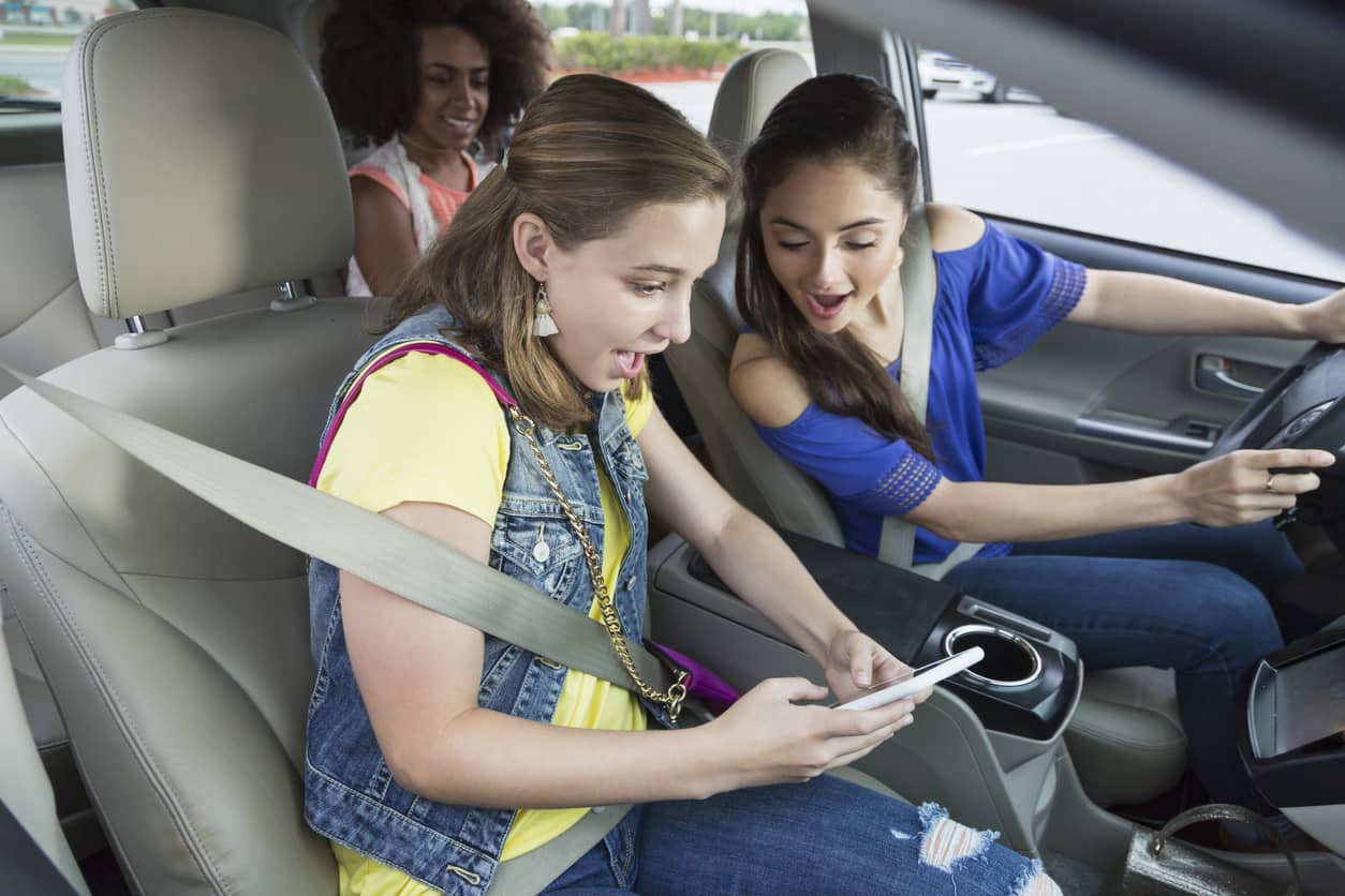 Teen girls on their smartphones texting