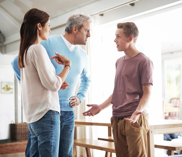 Teenage boy in confrontation with his parents