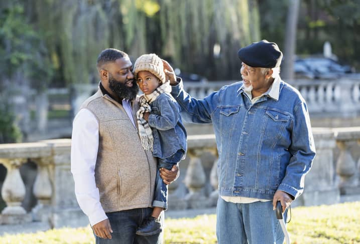 Three generation African American family walking in a park.