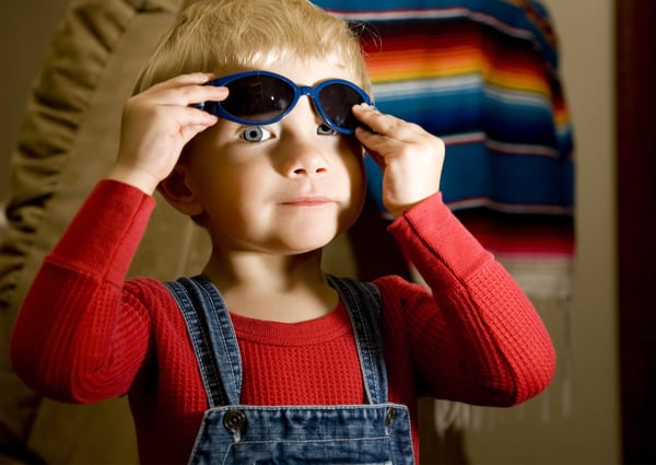 Cute toddler trying on sunglasses