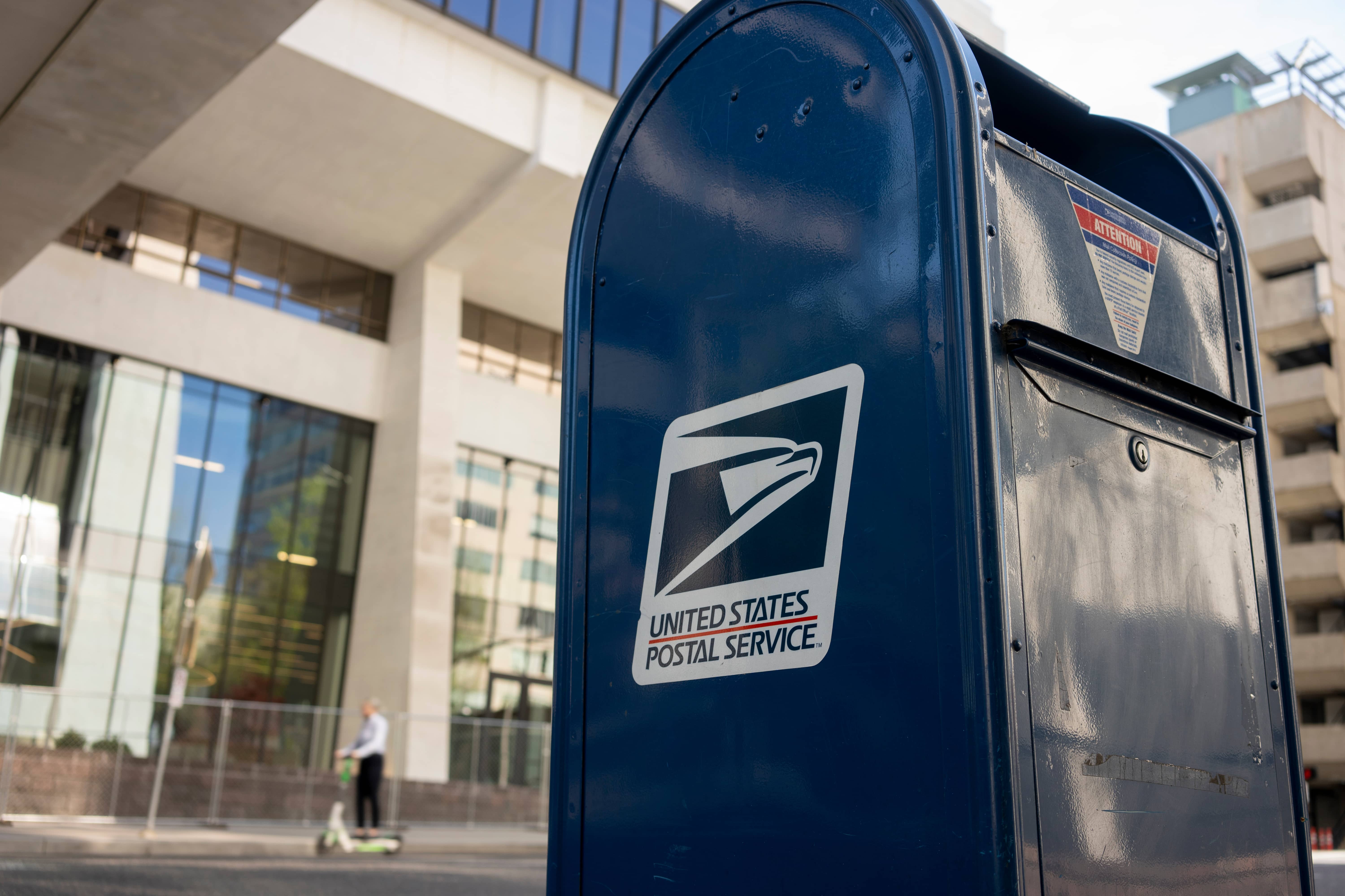 USPS mailbox in front of building symbolizing a struggling business