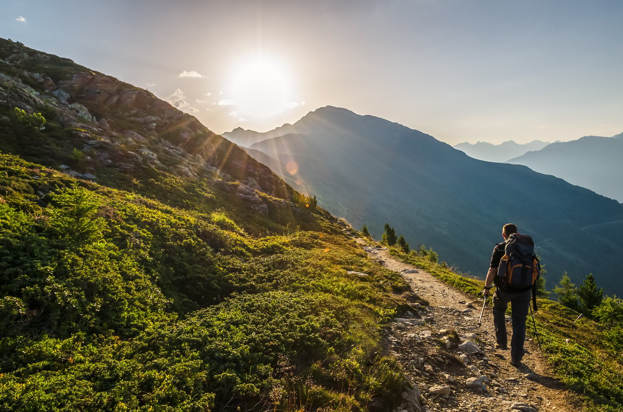 A man hiking in the alps on a journey of a thousand steps