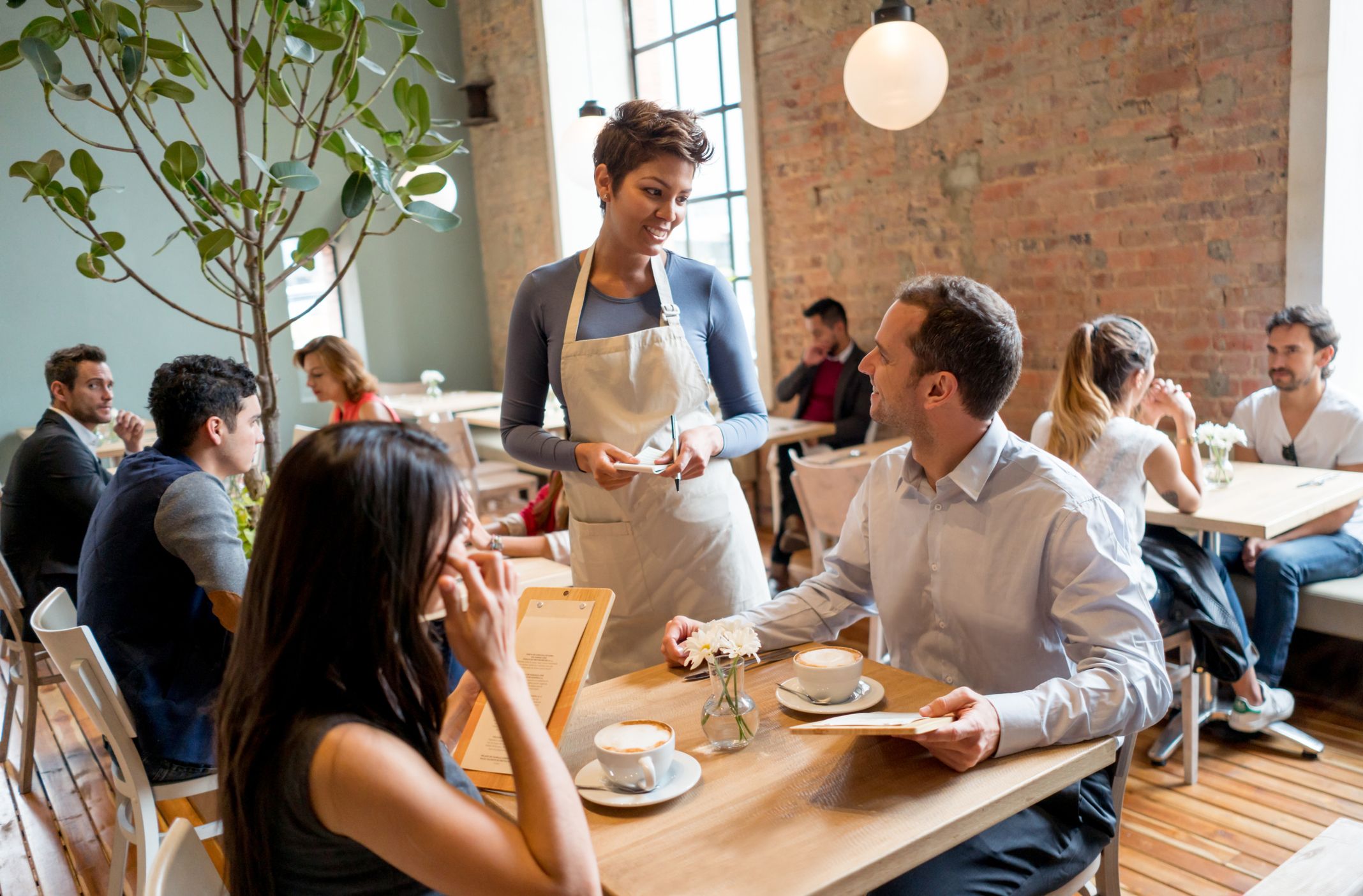 Waitress serving a couple at a restaurant