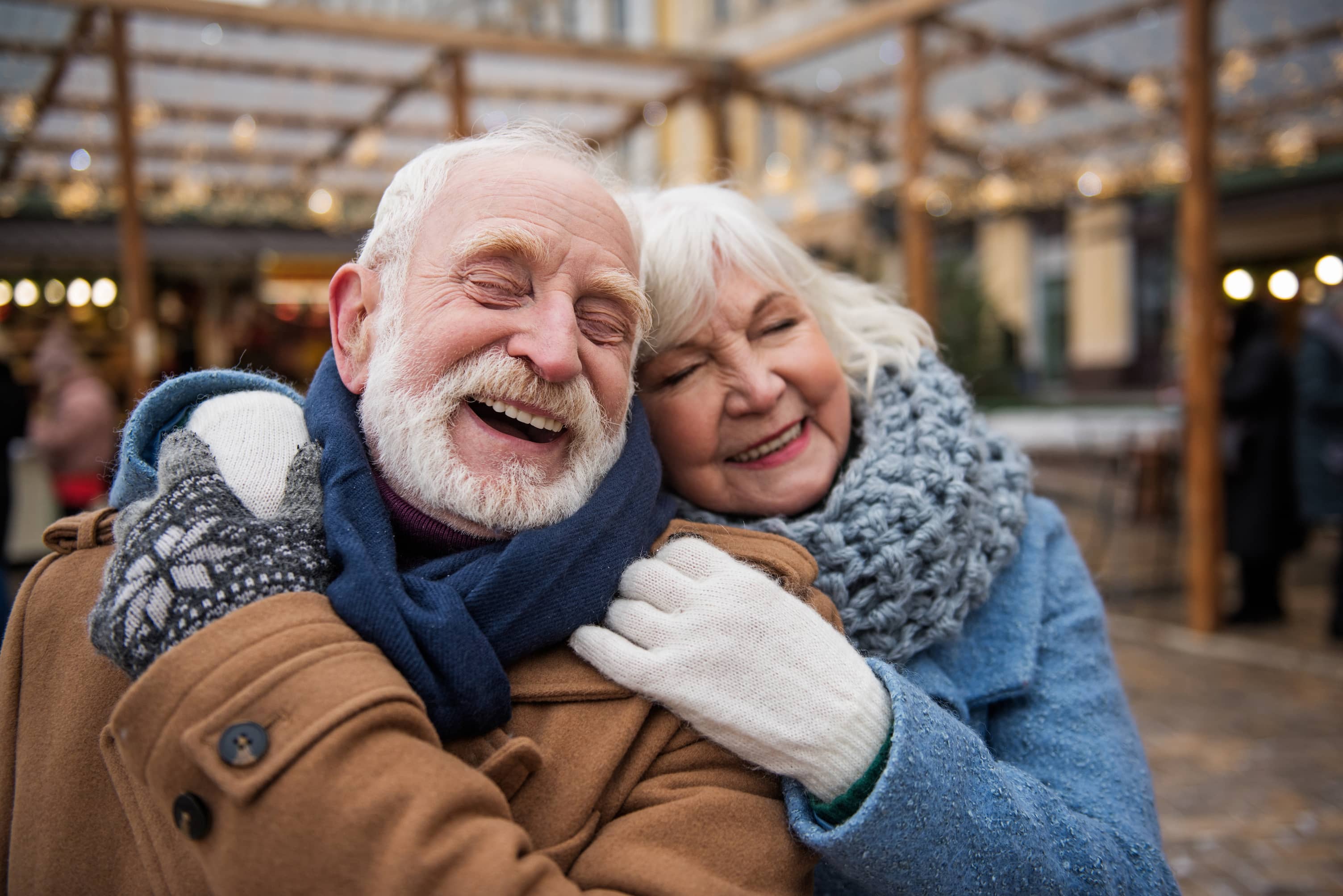 A happy, older couple hugging. They have goodness of fit in their temperaments.