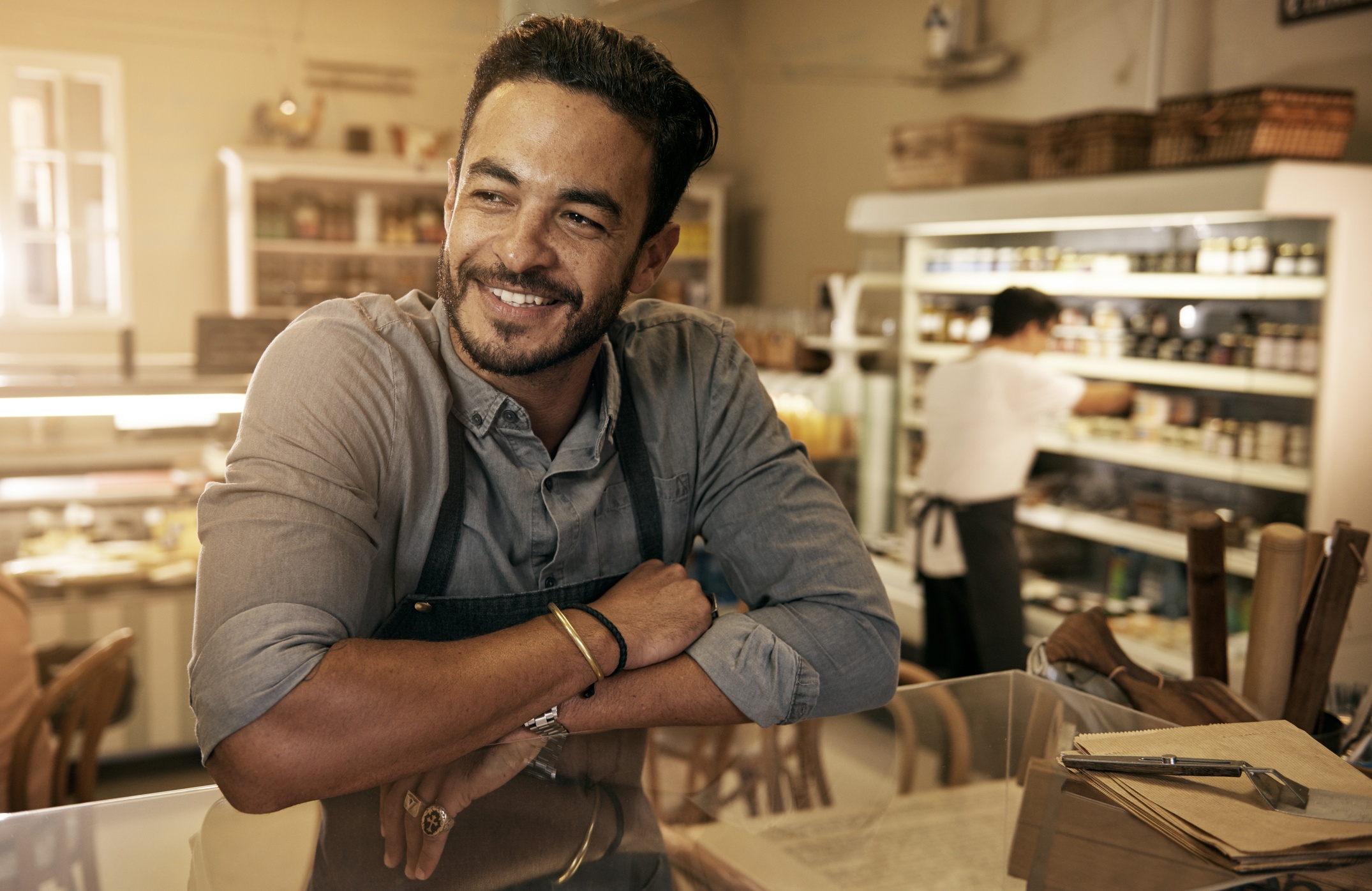 A happy man finds pleasure in serving at a deli