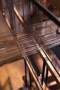 A loom weaving a blanket