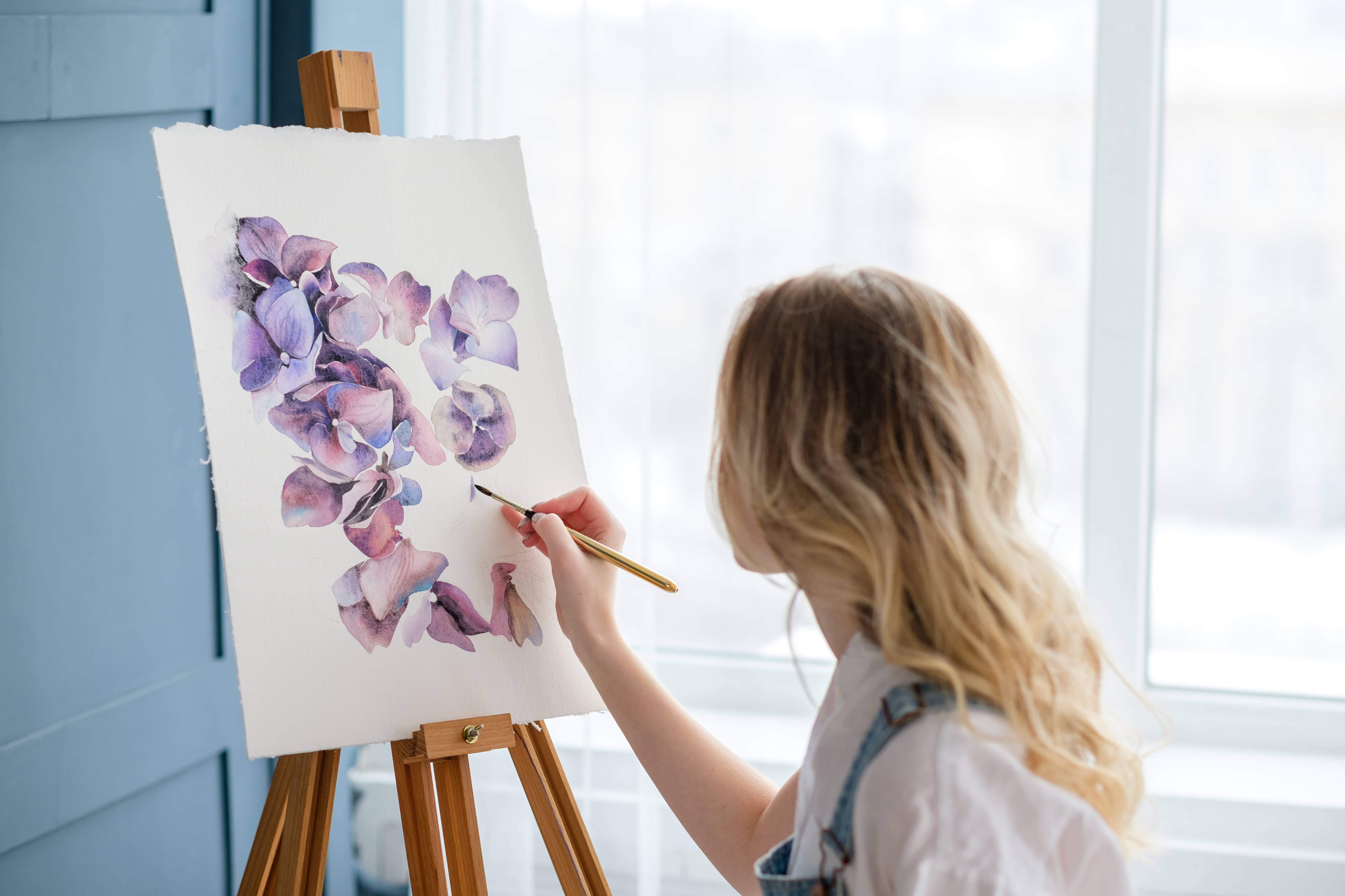 Woman painting to enhance her emotional well being