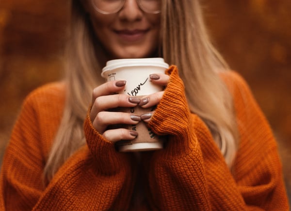 A young woman with a warm drink