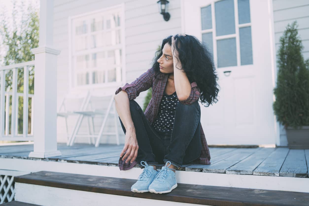 Mother self-calming as she sits on the front porch