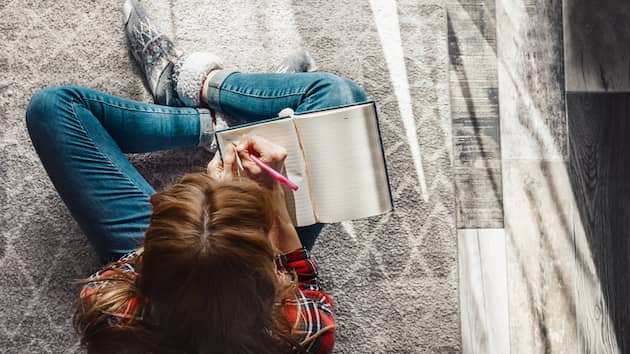 Aerial view of a woman journaling.