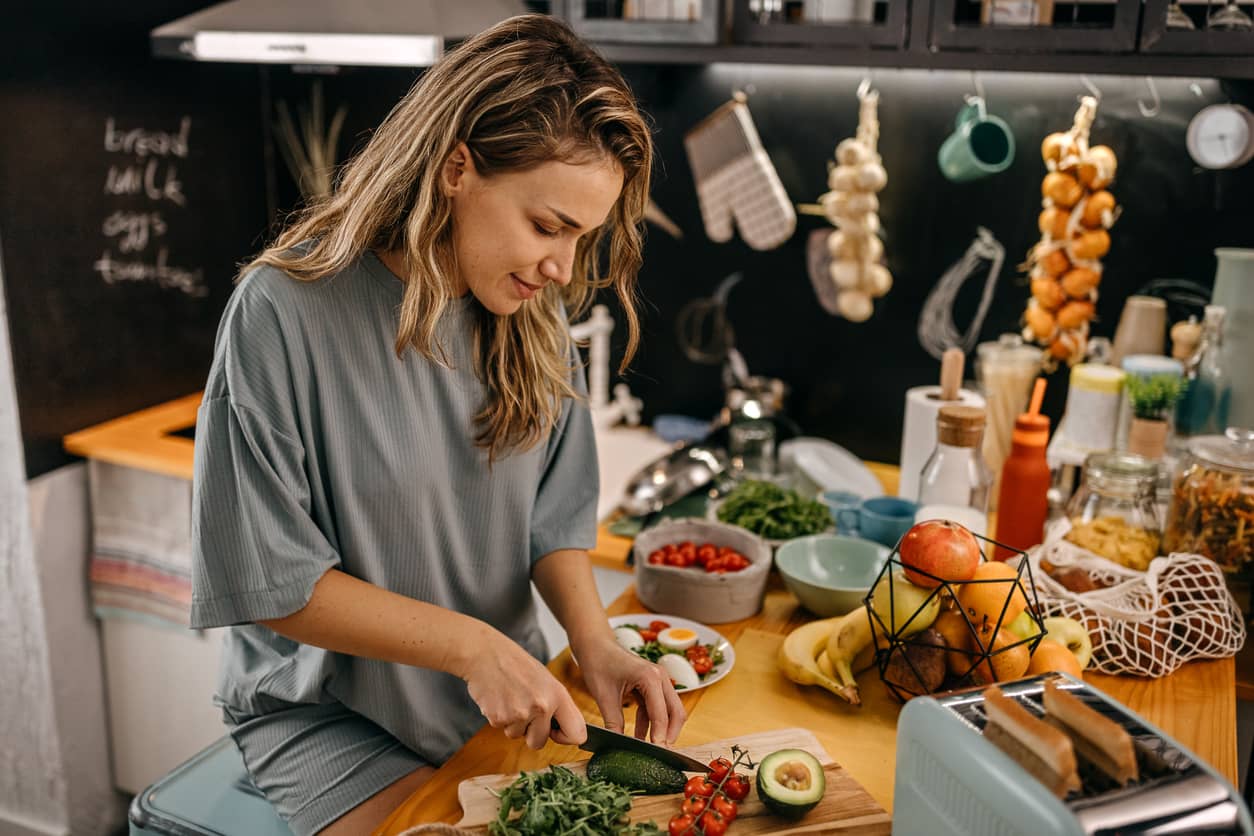 A women cutting in a modern kitchen.