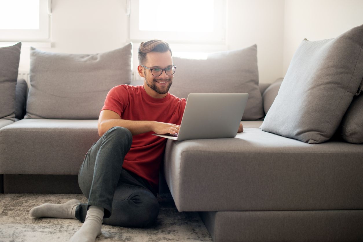 Man working on his computer in a minimalist home