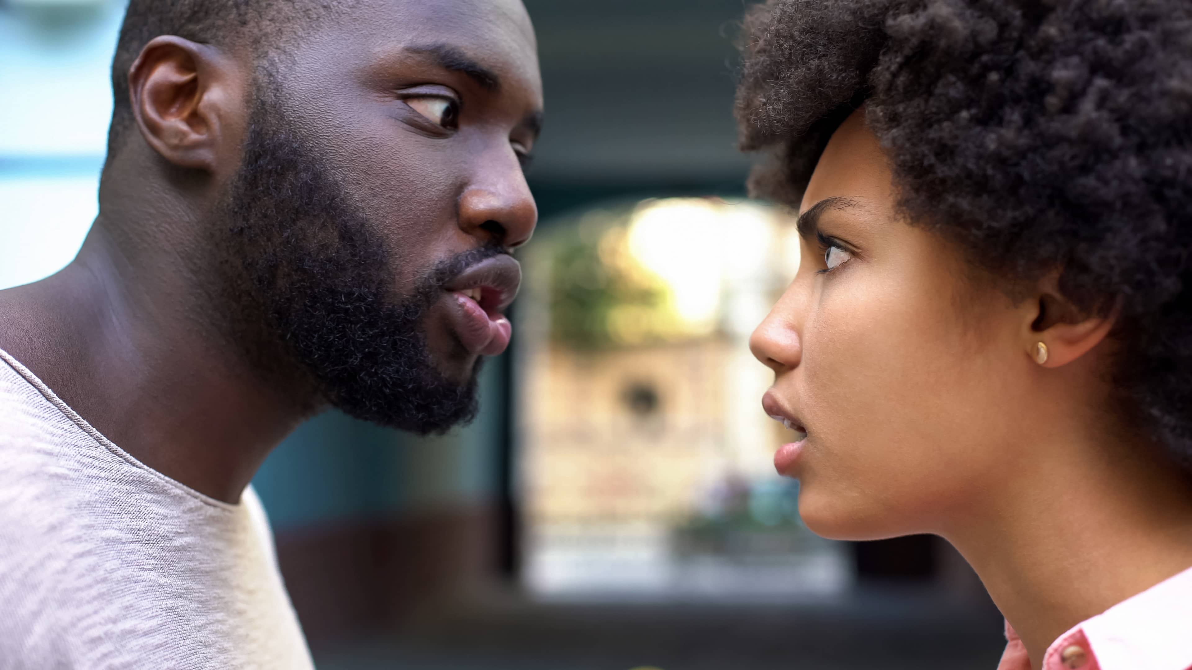 A young AfroAmerican married couple arguing and in need of conflict resolution.