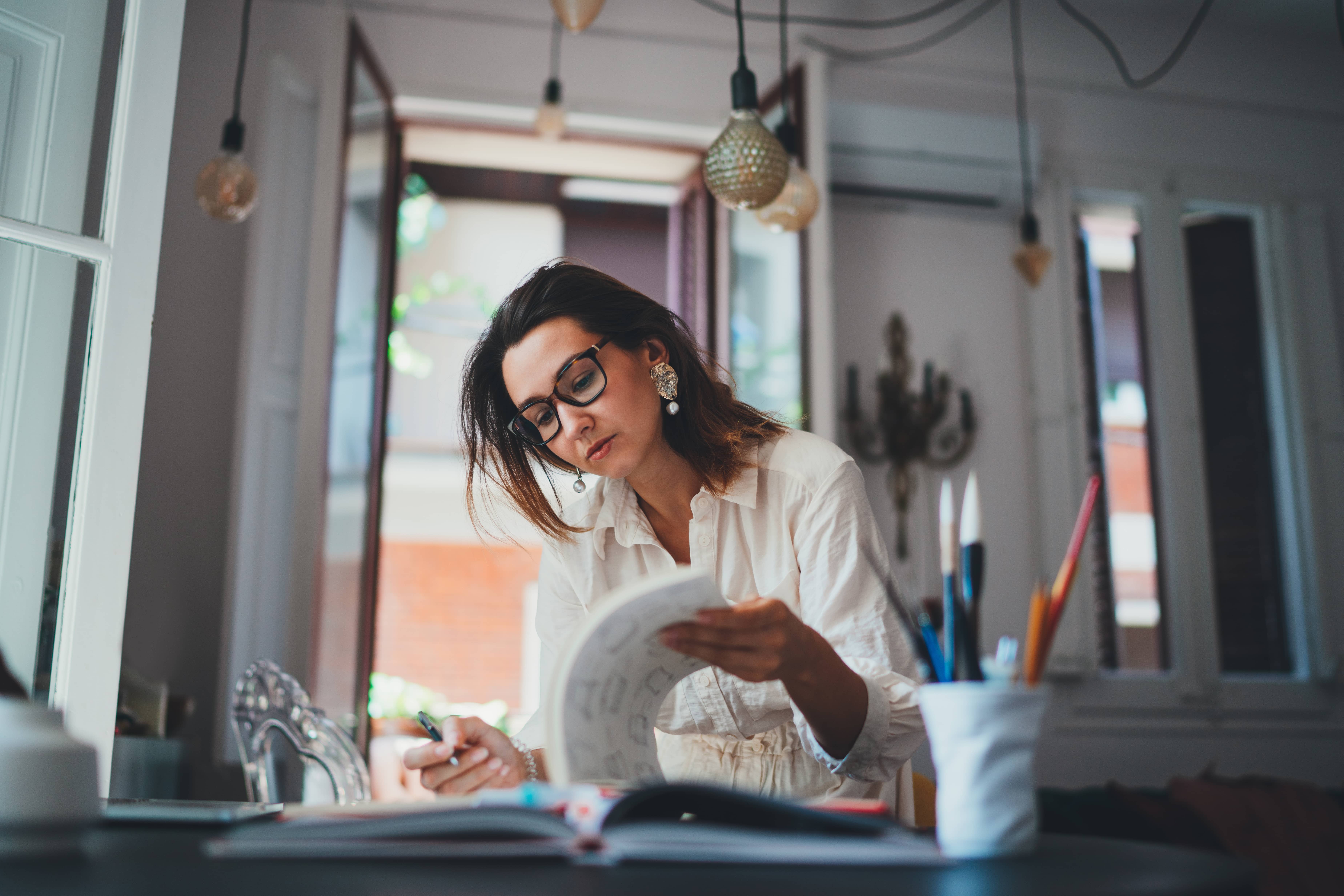 Young creative woman doing focused work in design agency.