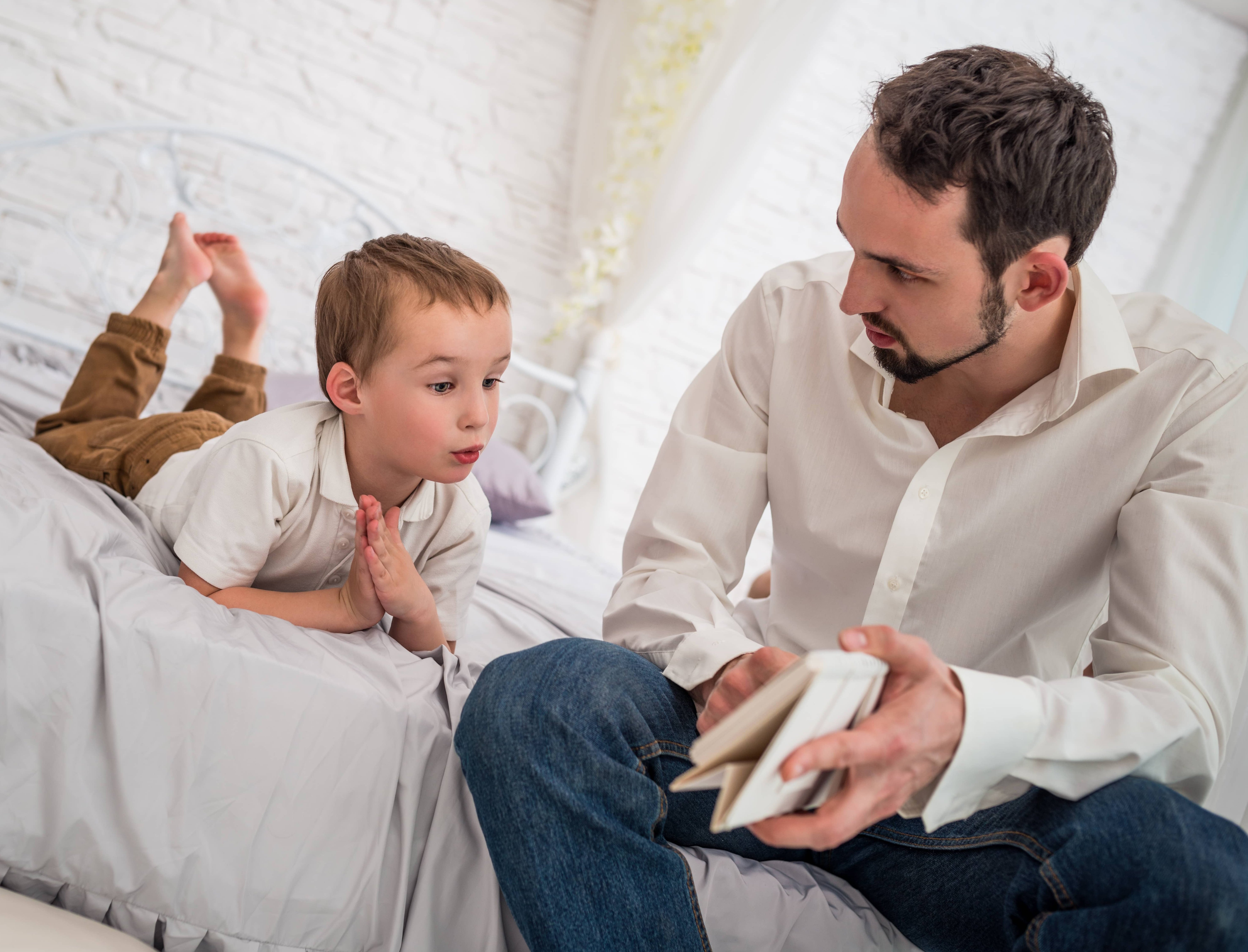 Young father listening intently and empathizing with his son.