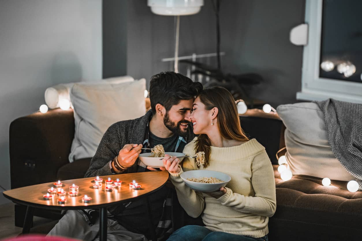 A young couple celebrating Valentines Day with a romantic lunch at home.