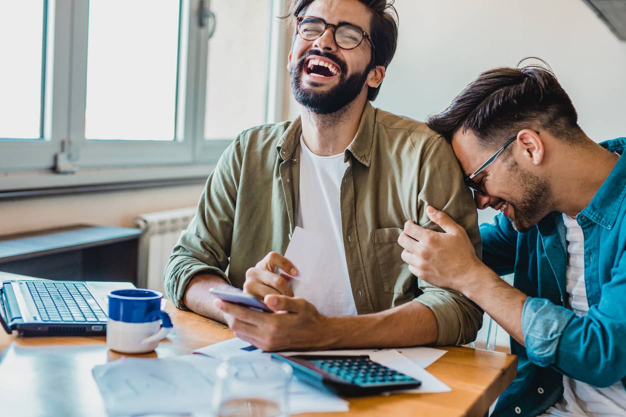 Young gay couple enjoying planning for their future