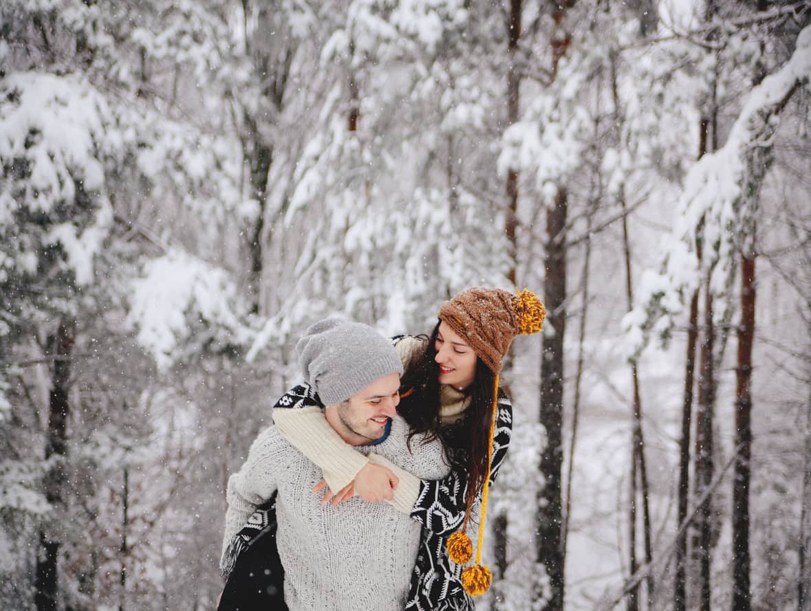 Young and happy couple hiking in the woods.