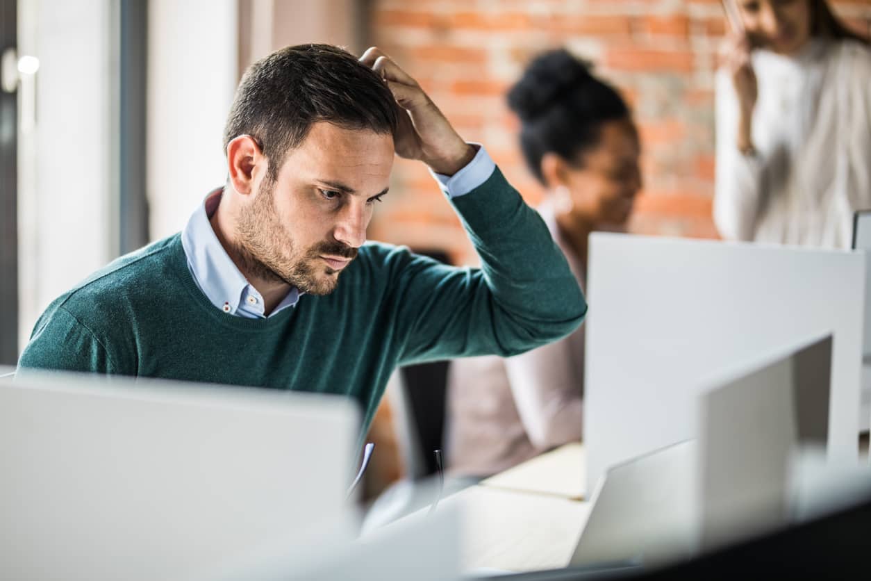 Young worried entrepreneur working at the computer.