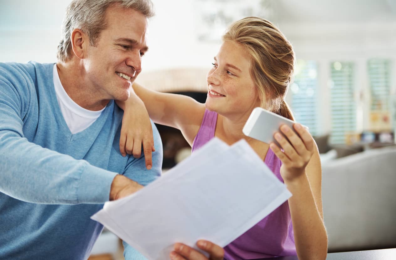 A father helping his teenage daughter set goals for the school year.