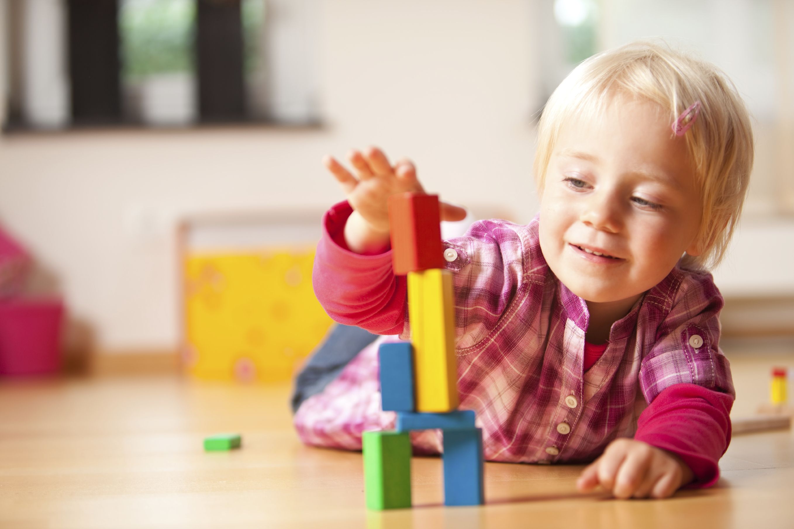 Preschool child building blocks happily