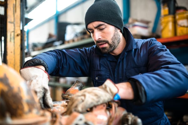 Mechanic working on a truck engine with focused attention