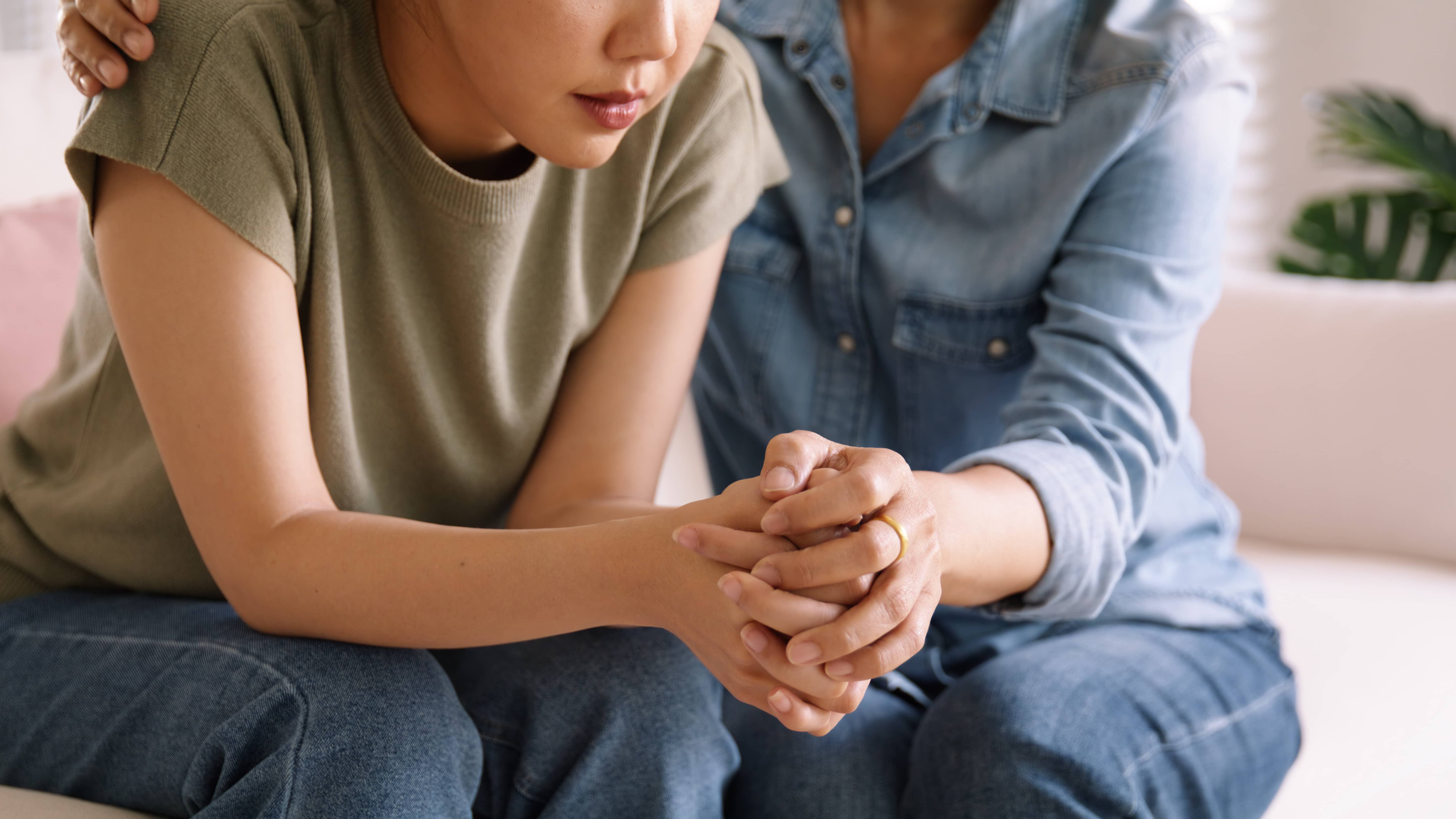 A loving mom comforting her daughter with empathy.